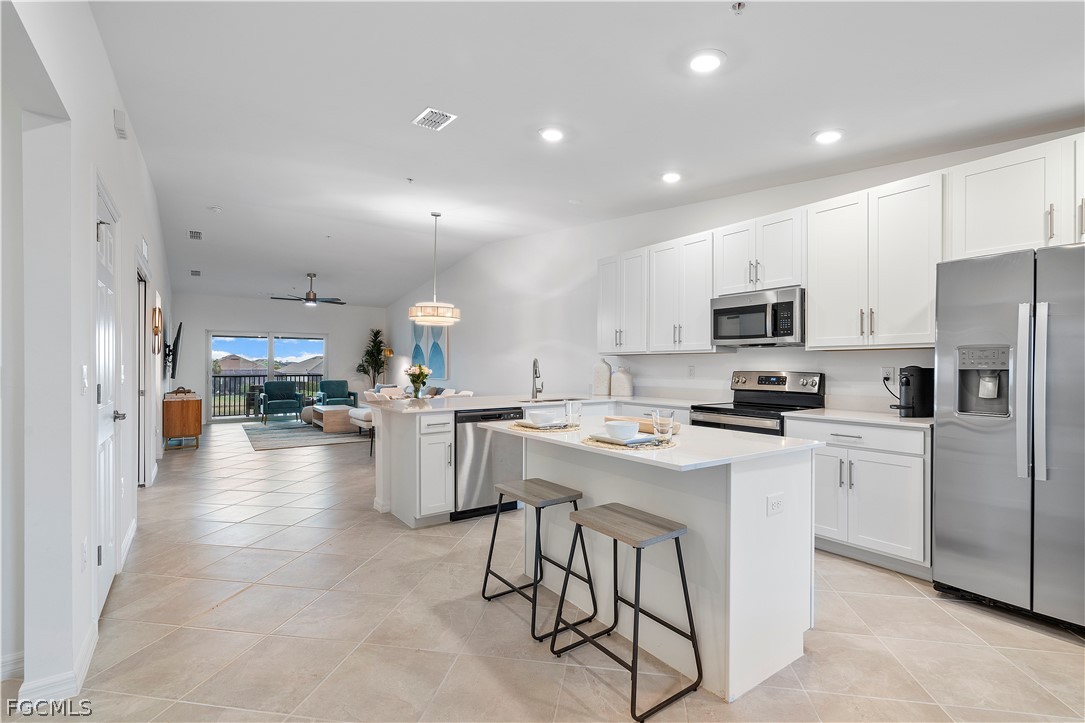 43996 Boardwalk Loop, Unit 1422 Punta Gorda, FL 33982 - Photo 3 of 37 a kitchen with refrigerator and cabinets