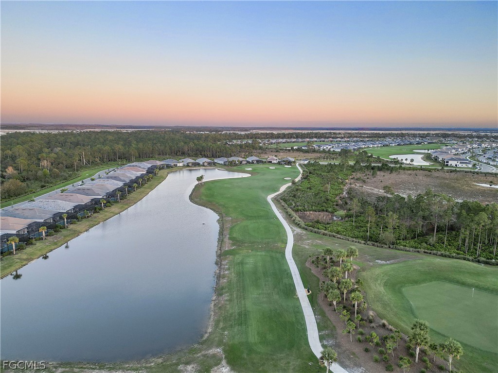 43996 Boardwalk Loop, Unit 1422 Punta Gorda, FL 33982 - Photo 32 of 37 an aerial view of a house with a yard and lake view
