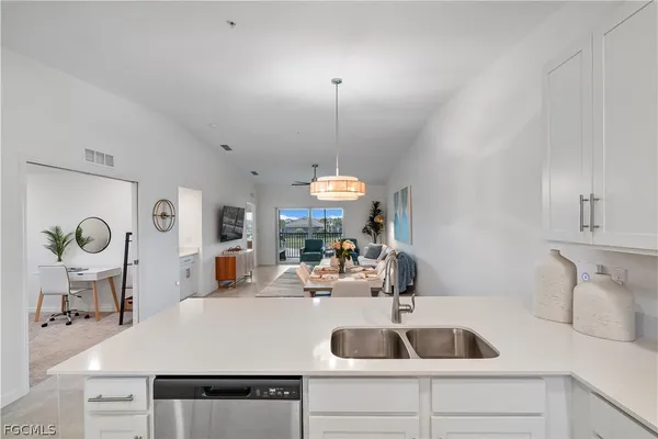 a kitchen with a sink and a refrigerator