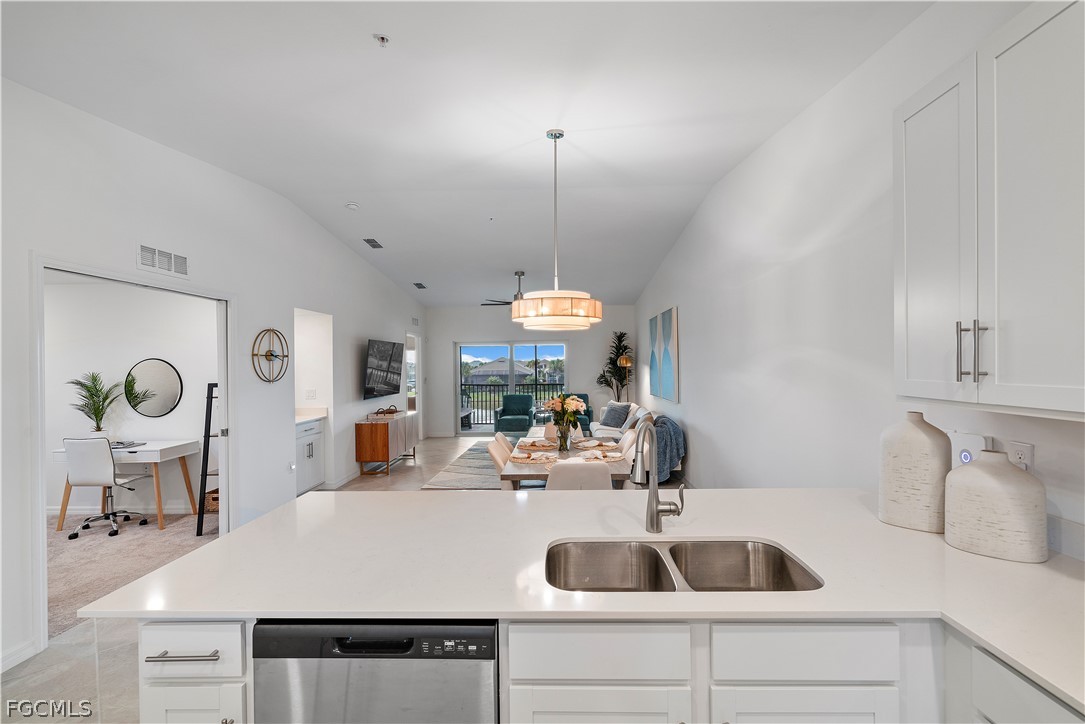 43996 Boardwalk Loop, Unit 1422 Punta Gorda, FL 33982 - Photo 7 of 37 a kitchen with a sink and a refrigerator