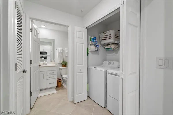 a room with white cabinets and sink