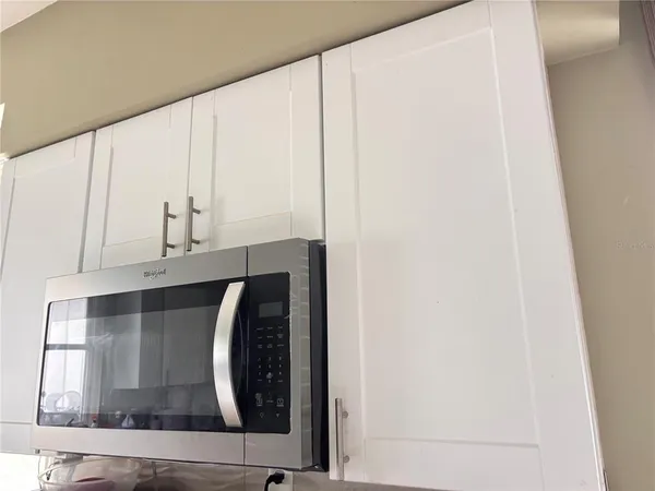 a view of a field with trees in the background