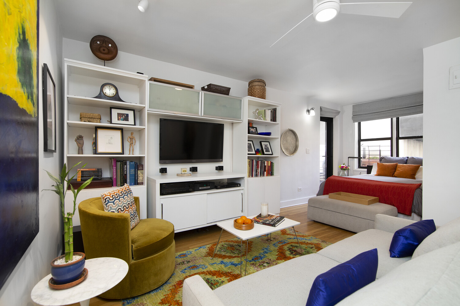 242 East 38th Street, Unit 2A Manhattan, NY 10016 - Photo 2 of 8 a living room with furniture and a flat screen tv