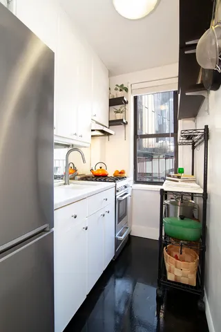 a kitchen with a refrigerator and windows