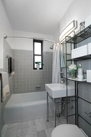 a bathroom with a sink a toilet a mirror and bathtub