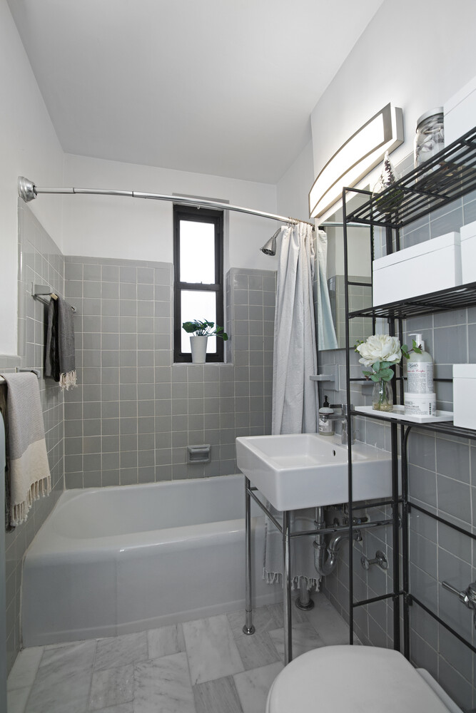 242 East 38th Street, Unit 2A Manhattan, NY 10016 - Photo 5 of 8 a bathroom with a sink a toilet a mirror and bathtub