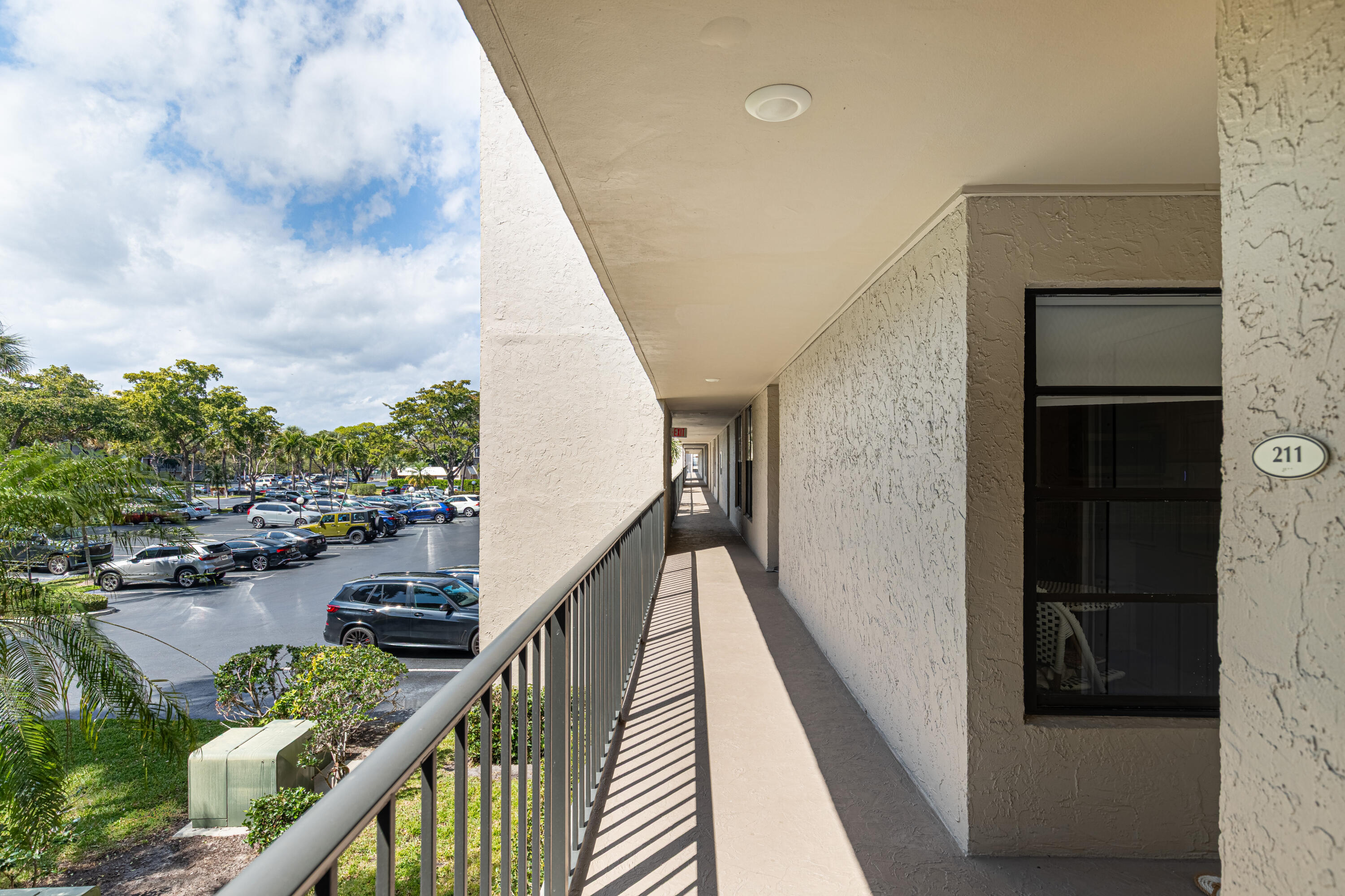 6 Royal Palm Way, Unit 211 Boca Raton, FL 33432 - Photo 29 of 32 Boca Bayou exterior hallway at front doo
