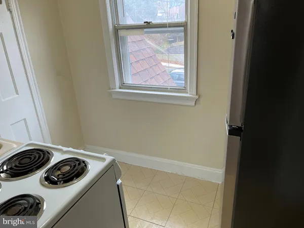 a view of a storage and utility room with a fridge