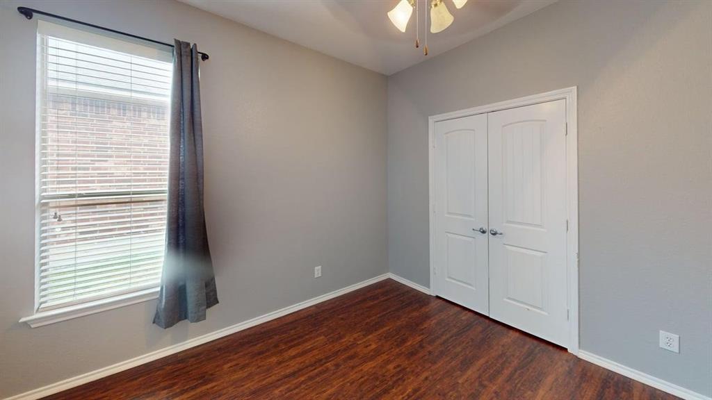14308 Polo Ranch Street Fort Worth, TX 76052 - Photo 11 of 19 Room featuring wood-finish flooring, a double-door closet, and a window with blinds