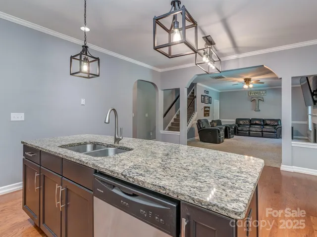 a kitchen with a granite countertop center island and stainless steel appliances