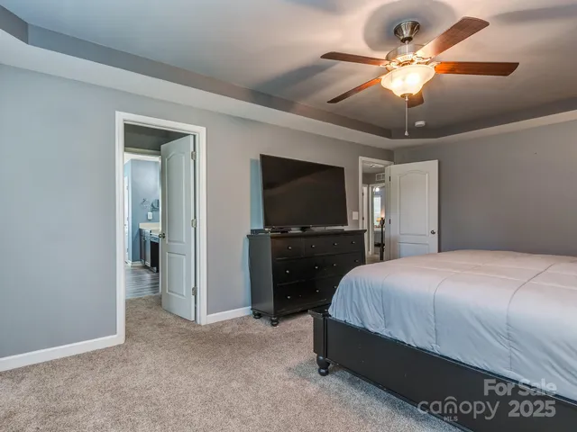 a spacious bathroom with a tub sink and mirror