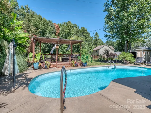 a view of a house with backyard porch and sitting area