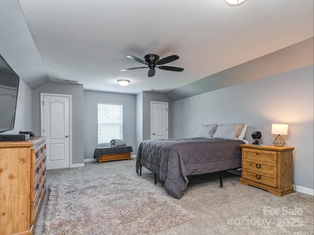 a bedroom with a bed and a ceiling fan