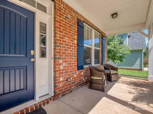 a balcony with furniture and a gate