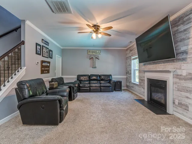 a living room with furniture fireplace and flat screen tv