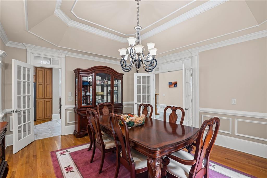 5053 Chapel Crossing Road Douglasville, GA 30135 - Photo 13 of 94 a view of a dining room with furniture a chandelier and wooden floor