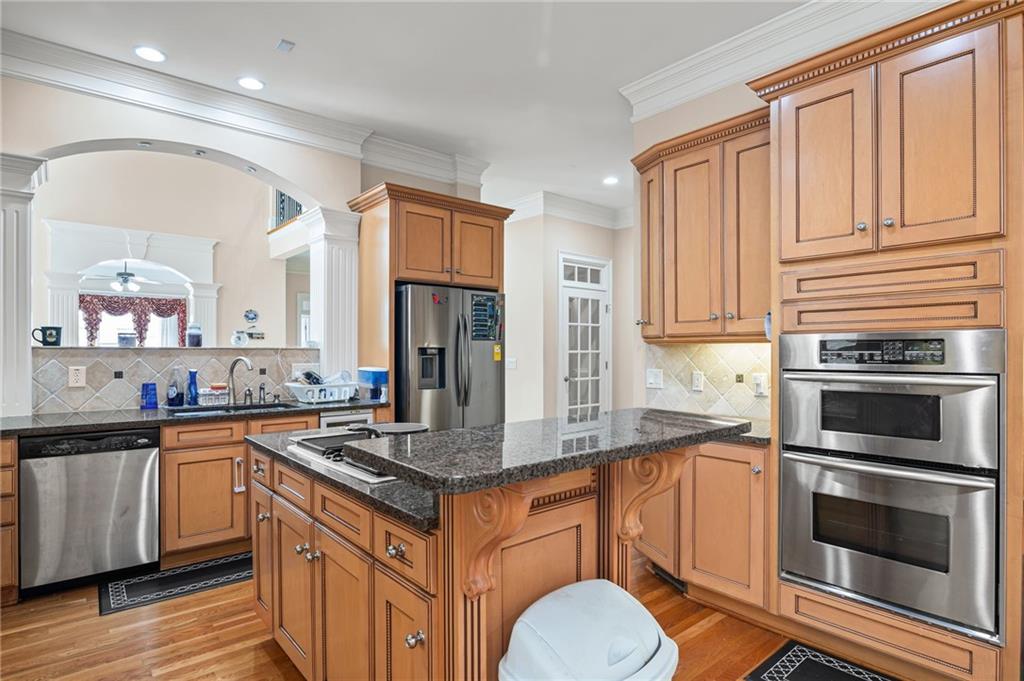 5053 Chapel Crossing Road Douglasville, GA 30135 - Photo 19 of 94 a kitchen with stainless steel appliances granite countertop a stove a sink and a microwave
