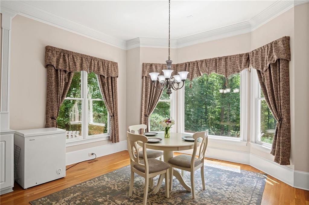 5053 Chapel Crossing Road Douglasville, GA 30135 - Photo 25 of 94 a dining room with furniture a chandelier and a rug