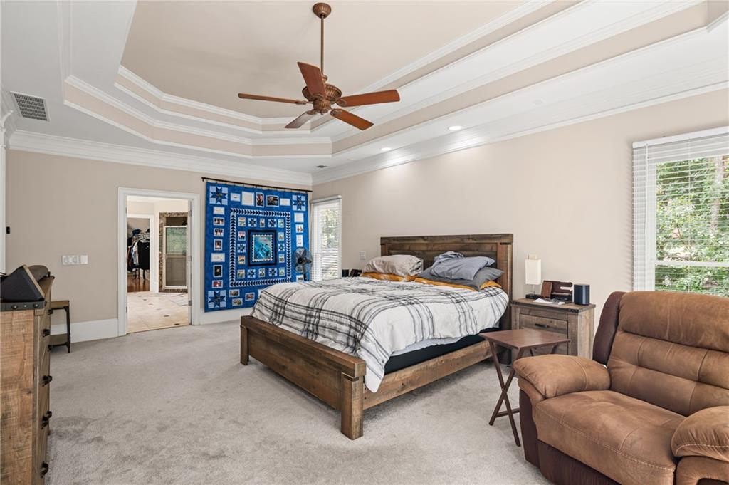 5053 Chapel Crossing Road Douglasville, GA 30135 - Photo 33 of 94 a spacious bedroom with a bed couch and a large window