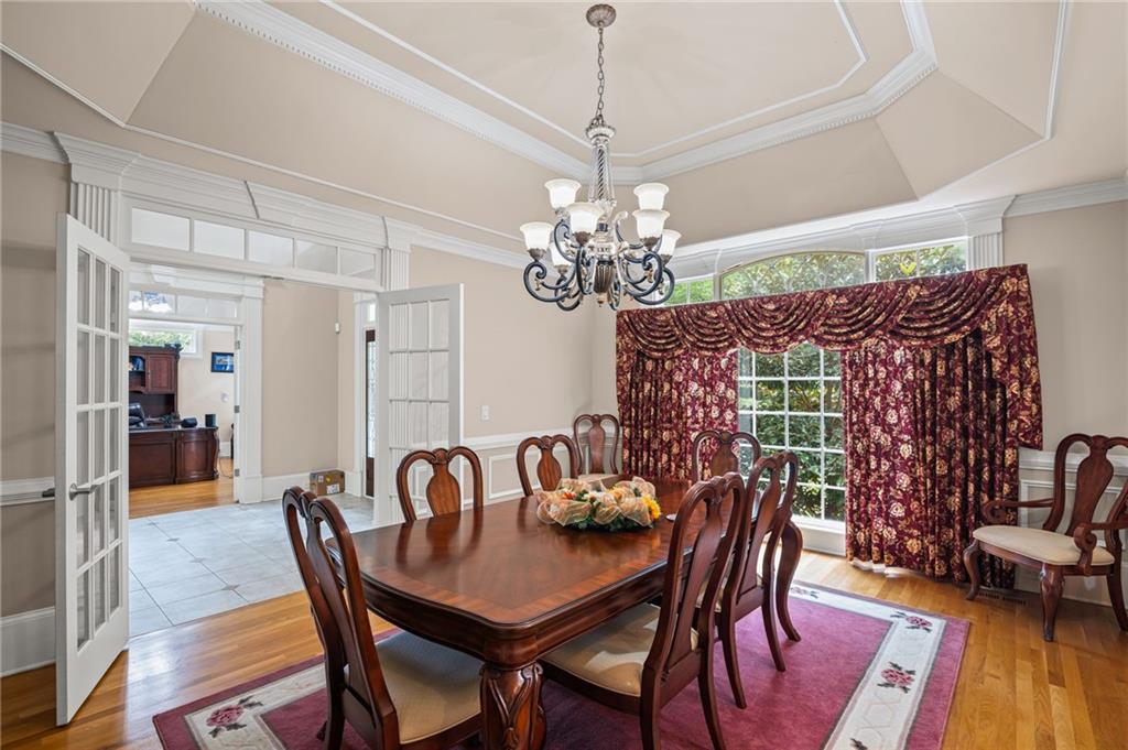 5053 Chapel Crossing Road Douglasville, GA 30135 - Photo 4 of 94 a view of a dining room with furniture wooden floor and chandelier