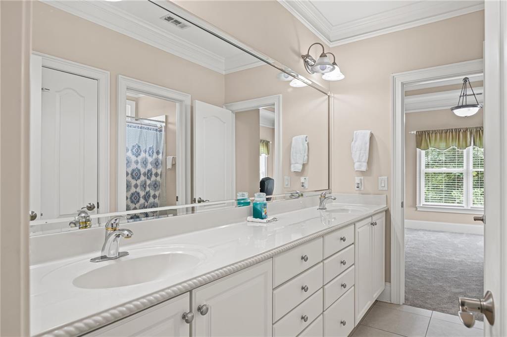 5053 Chapel Crossing Road Douglasville, GA 30135 - Photo 48 of 94 a bathroom with double vanity sinks and a mirror