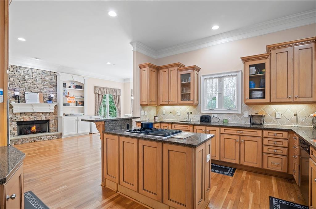 5053 Chapel Crossing Road Douglasville, GA 30135 - Photo 6 of 94 a kitchen with stainless steel appliances granite countertop a sink stove and wooden cabinets
