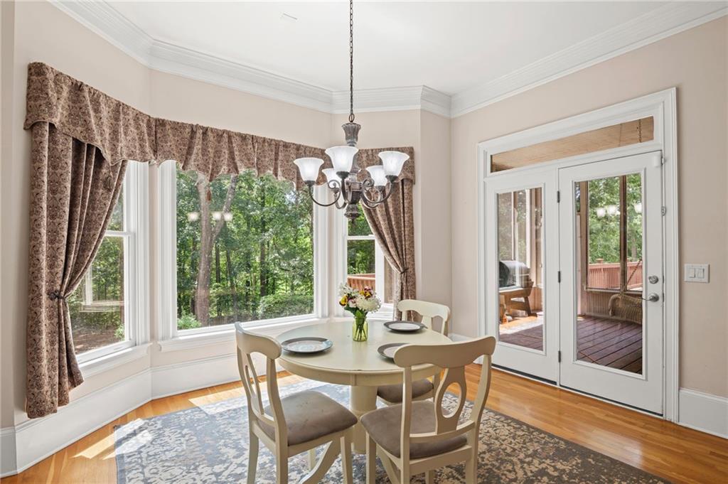 5053 Chapel Crossing Road Douglasville, GA 30135 - Photo 7 of 94 a view of a dining room with furniture wooden floor and a chandelier