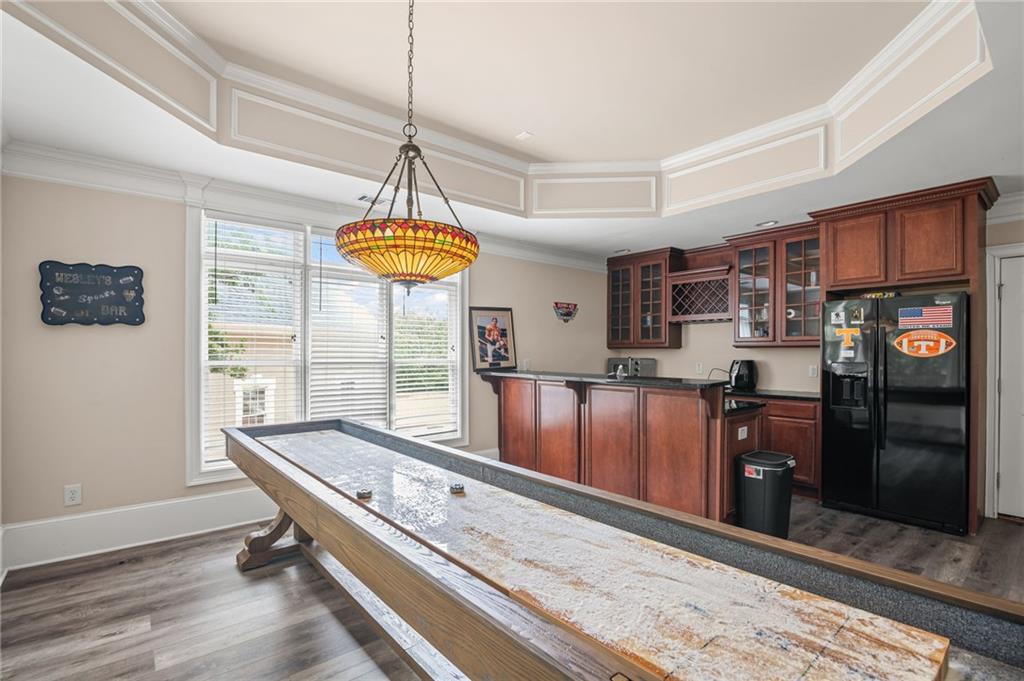 5053 Chapel Crossing Road Douglasville, GA 30135 - Photo 9 of 94 a room with stainless steel appliances kitchen island granite countertop a refrigerator a stove top oven and a dining table with wooden floor