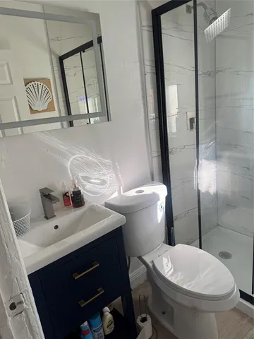 a bathroom with a sink mirror vanity and toilet