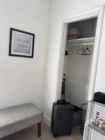 a view of room with stairs and closet