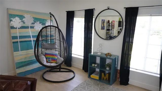 a view of a livingroom with furniture mirror and window