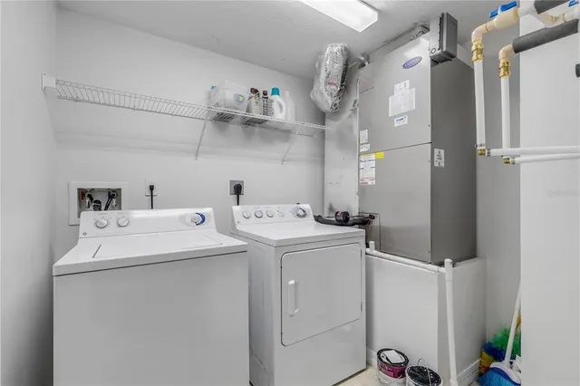 a living room with furniture and a lamp