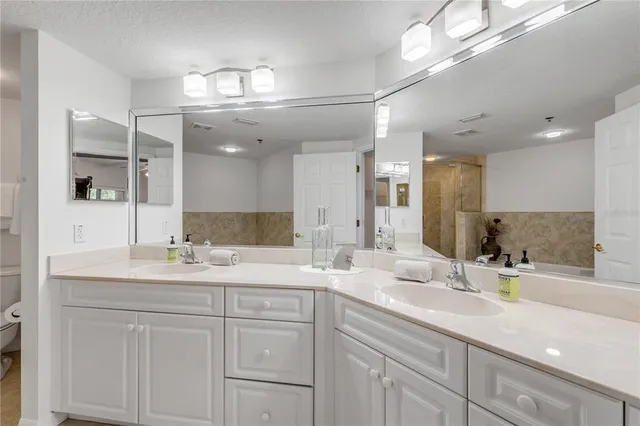 a bedroom with two beds and a chandelier