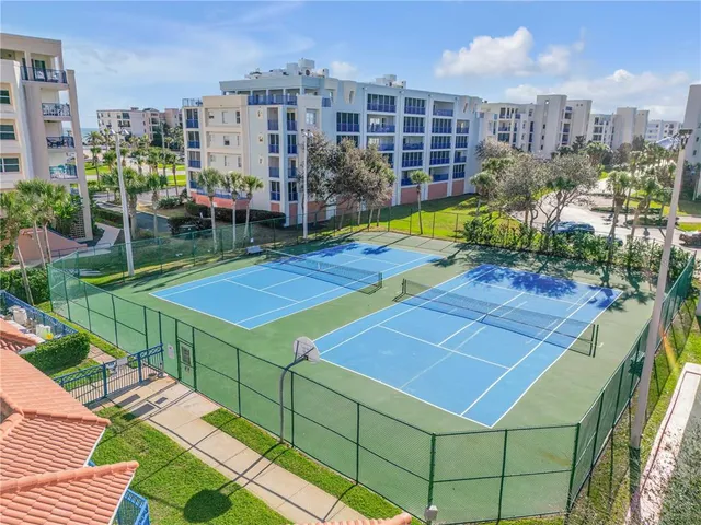 an aerial view of a residential apartment building with a yard and plants