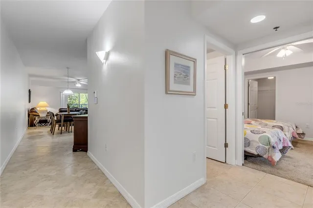 a dining room with furniture potted plants and a chandelier