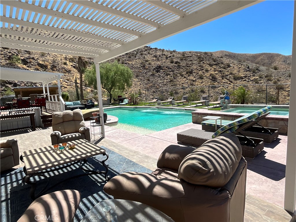 73405 Rask Road Desert Hot Springs, CA 92241 - Photo 12 of 26 a view of a patio with couches table chairs and a table