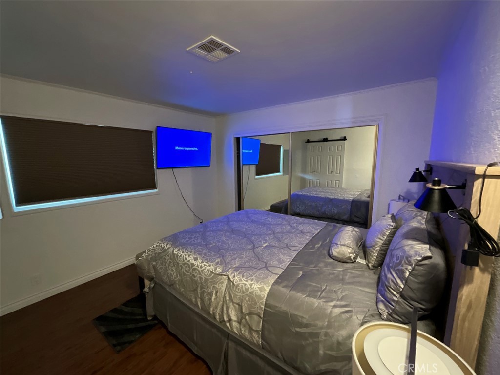 73405 Rask Road Desert Hot Springs, CA 92241 - Photo 15 of 26 a bedroom with a bed and a mirror