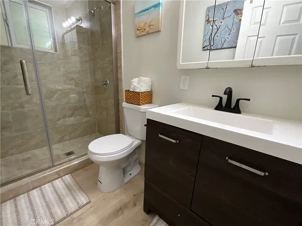 a bathroom with a sink a toilet and shower