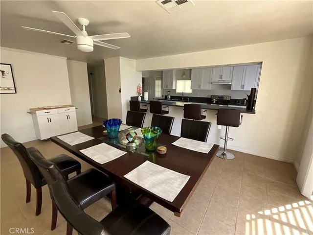 a view of a dining room with furniture and a chandelier