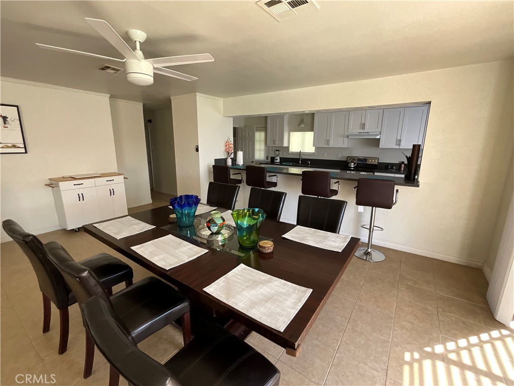 73405 Rask Road Desert Hot Springs, CA 92241 - Photo 21 of 26 a view of a dining room with furniture and a chandelier