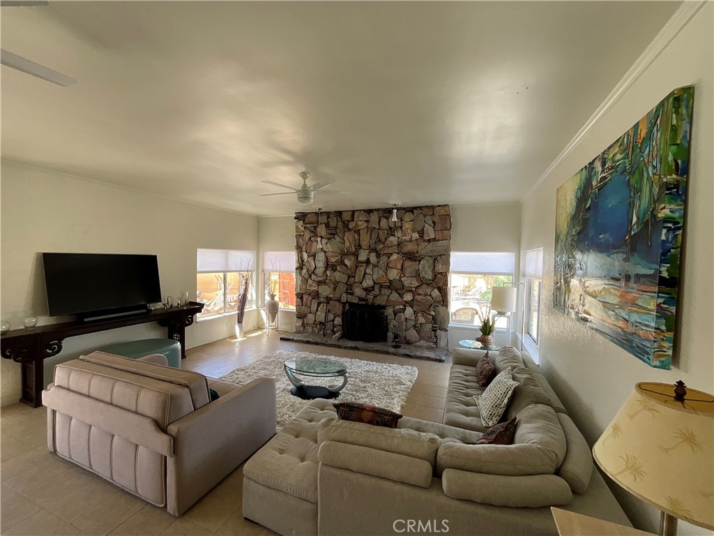 73405 Rask Road Desert Hot Springs, CA 92241 - Photo 23 of 26 a living room with furniture and a fireplace