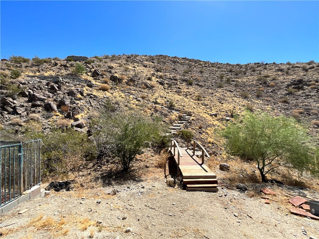 73405 Rask Road Desert Hot Springs, CA 92241 - Photo 4 of 26 a view of a dry yard with wooden fence