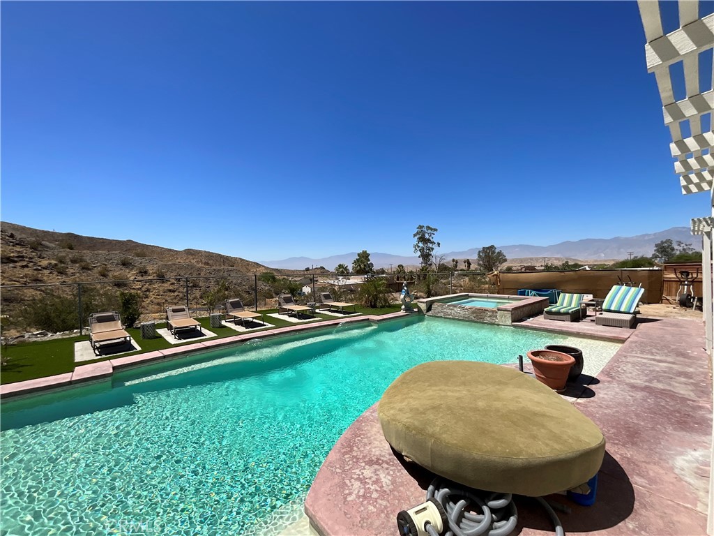 73405 Rask Road Desert Hot Springs, CA 92241 - Photo 5 of 26 a view of a swimming pool and lounge chairs
