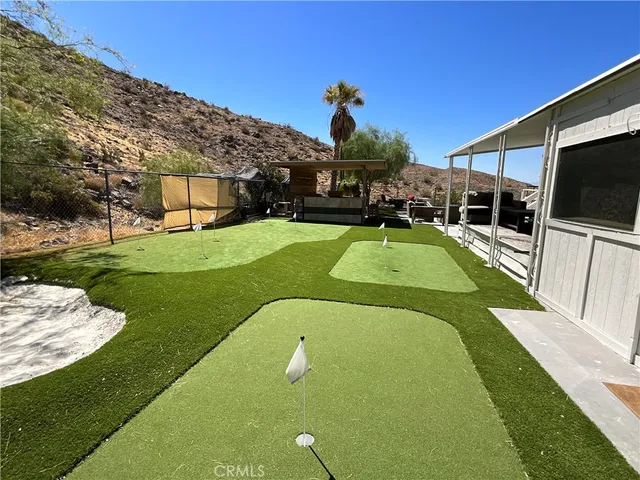 a view of a swimming pool with a garden and plants