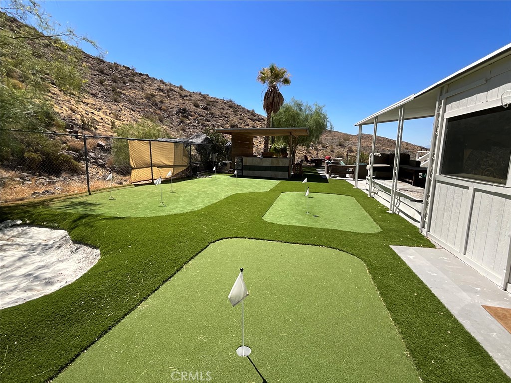 73405 Rask Road Desert Hot Springs, CA 92241 - Photo 7 of 26 a view of a swimming pool with a garden and plants