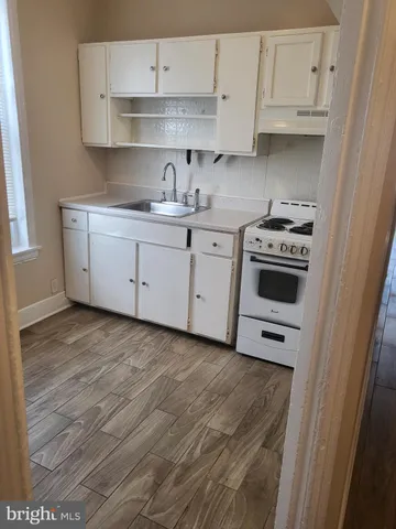 a kitchen with cabinets and appliances