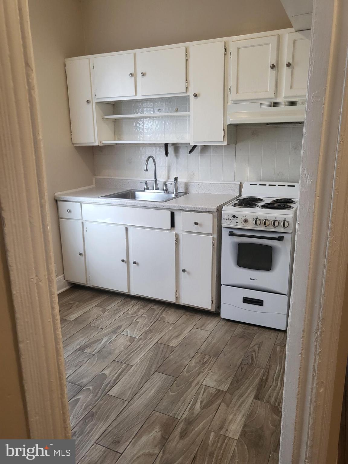 5820 Arch Street Philadelphia, PA 19139 - Photo 6 of 18 a kitchen with stainless steel appliances granite countertop a stove a sink and white cabinets