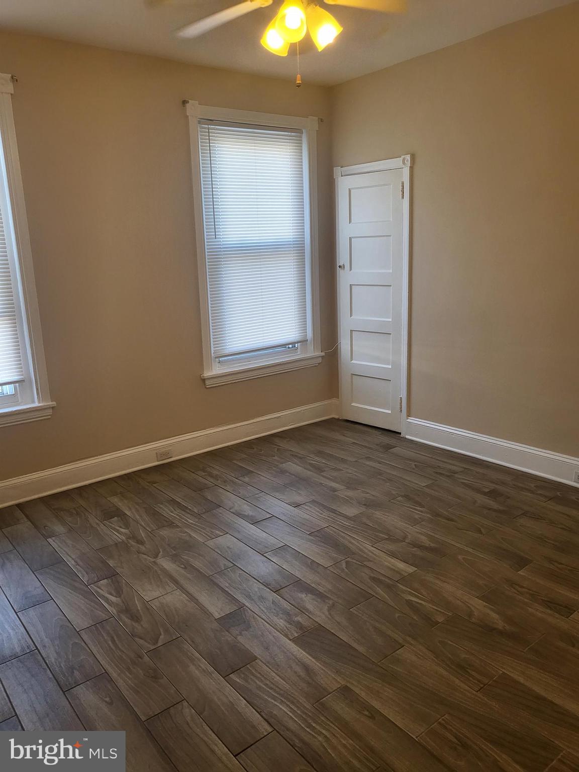5820 Arch Street Philadelphia, PA 19139 - Photo 8 of 18 an empty room with wooden floor and windows