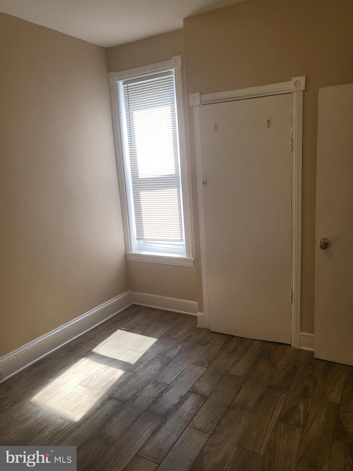 5820 Arch Street Philadelphia, PA 19139 - Photo 9 of 18 an empty room with wooden floor and windows