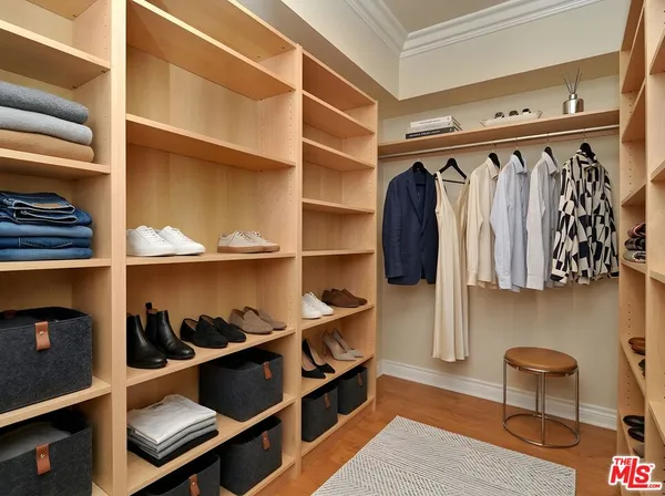 a view of walk in closet with empty racks
